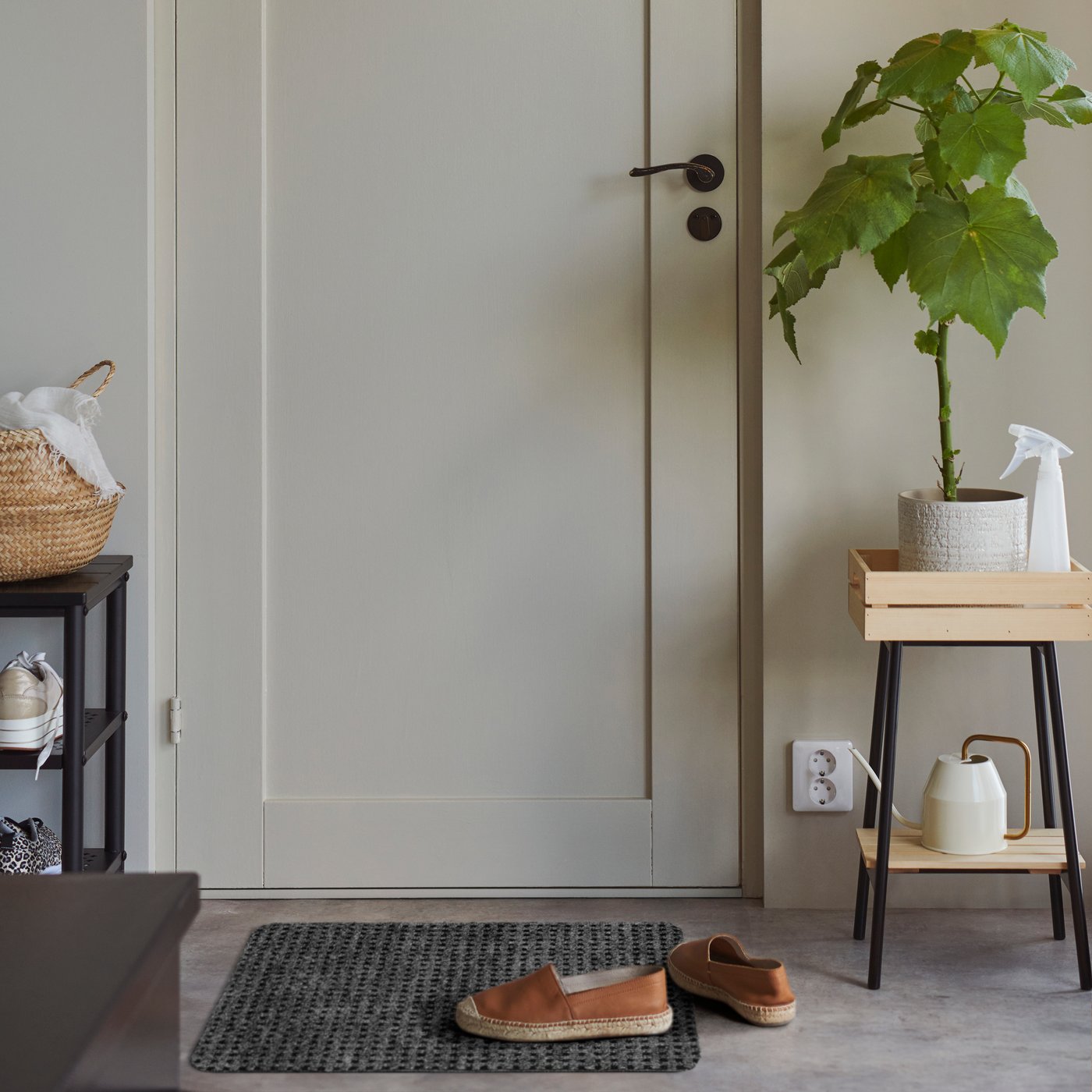 A grey FRIKTION door mat