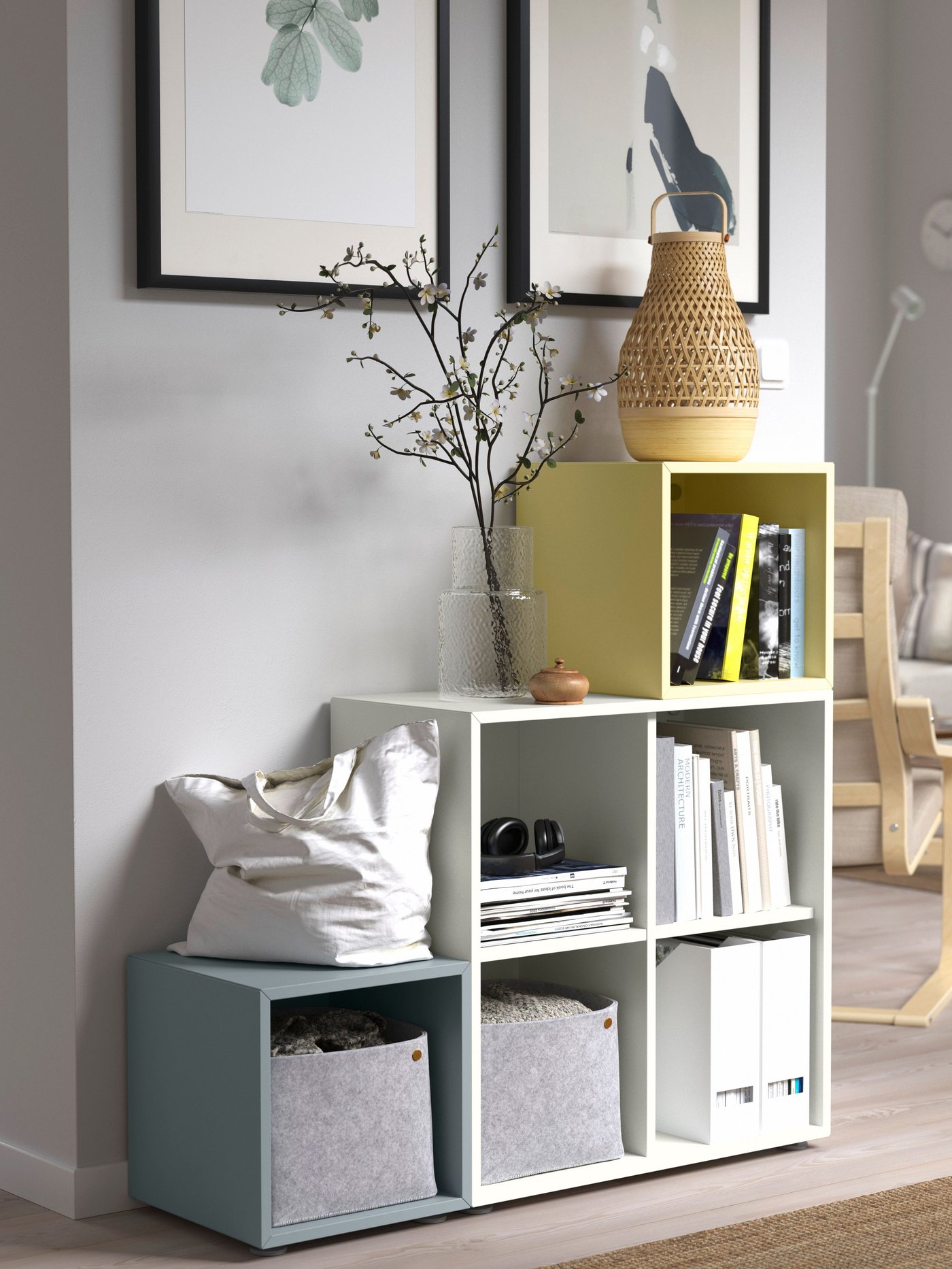 A light-green EKET cabinet filled with books hangs on a panelled wall, framed by a bed and draping curtains in rosy shades.