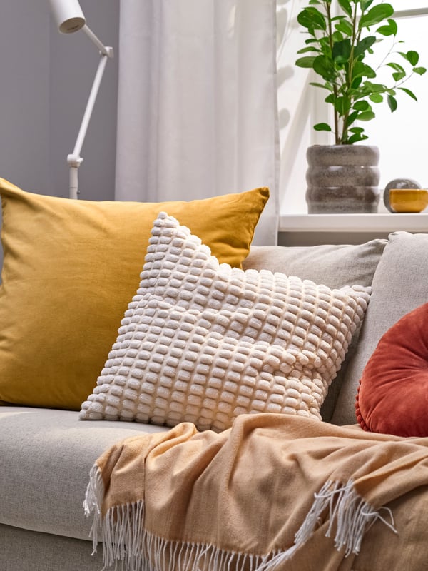 An yellow-brown SANELA cushion cover in the living room