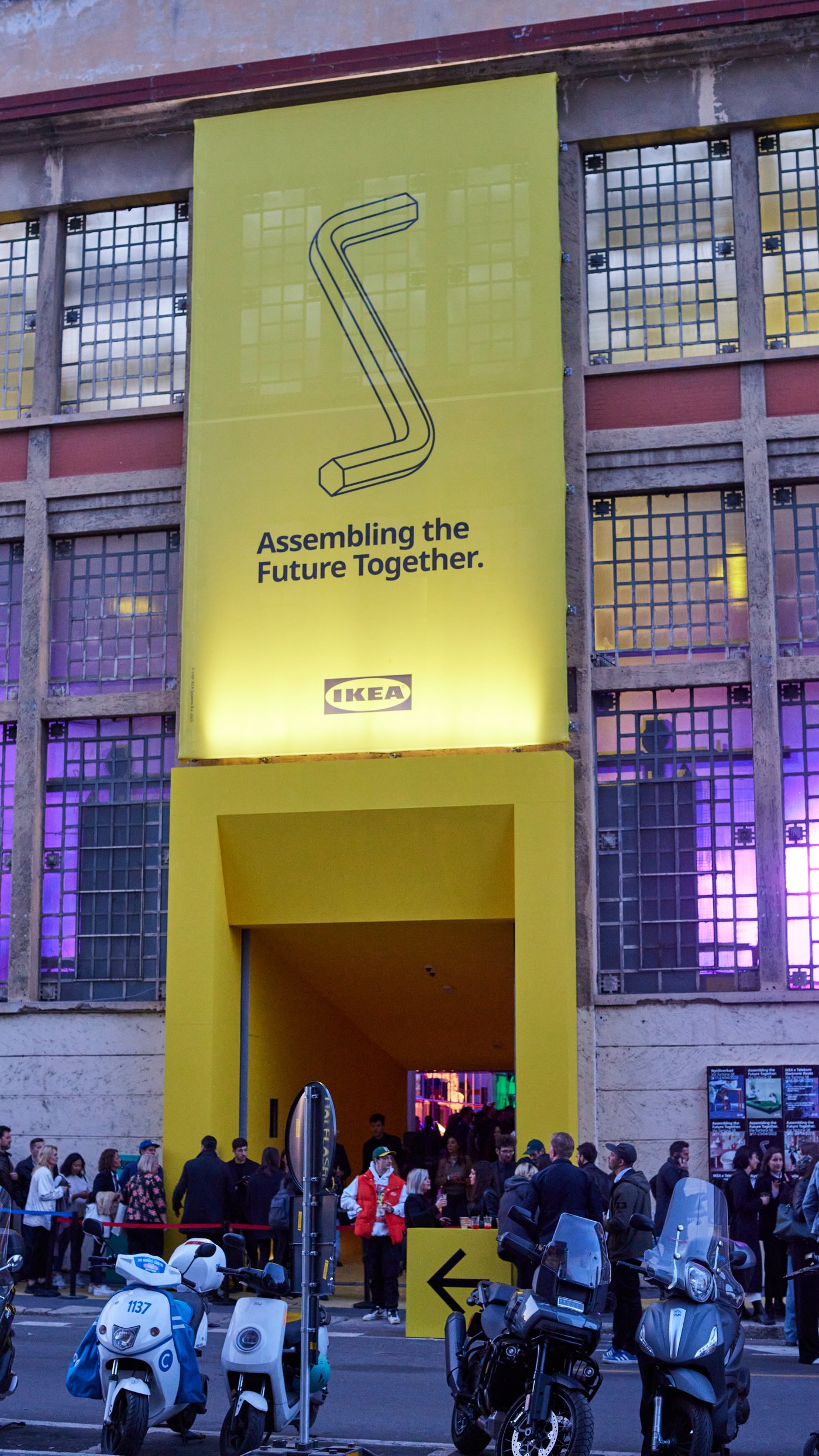 A big entrance otside of an facroty nin Milano with the IKEA sign.