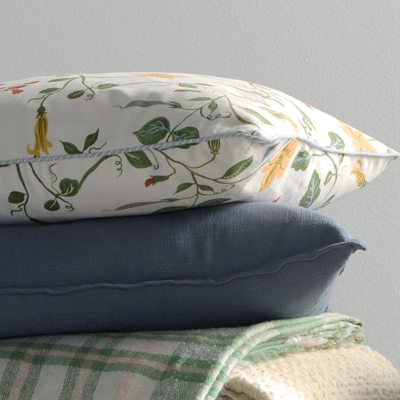 A white/floral pattern ÄNGSPALPMAL cushion cover