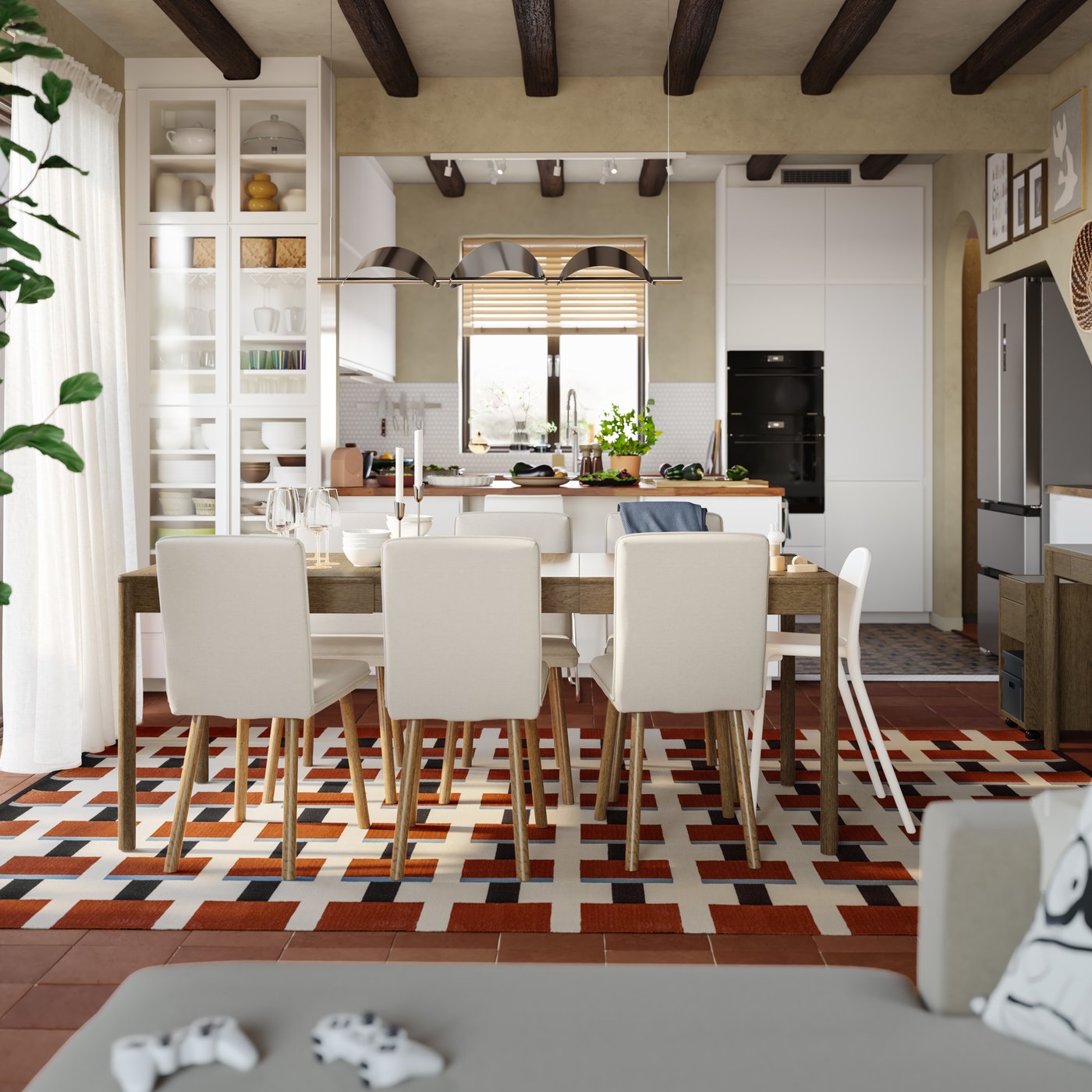 A dining room with a TONSTAD extendable table in brown stained oak veneer has a kitchen with a peninsula in the background.