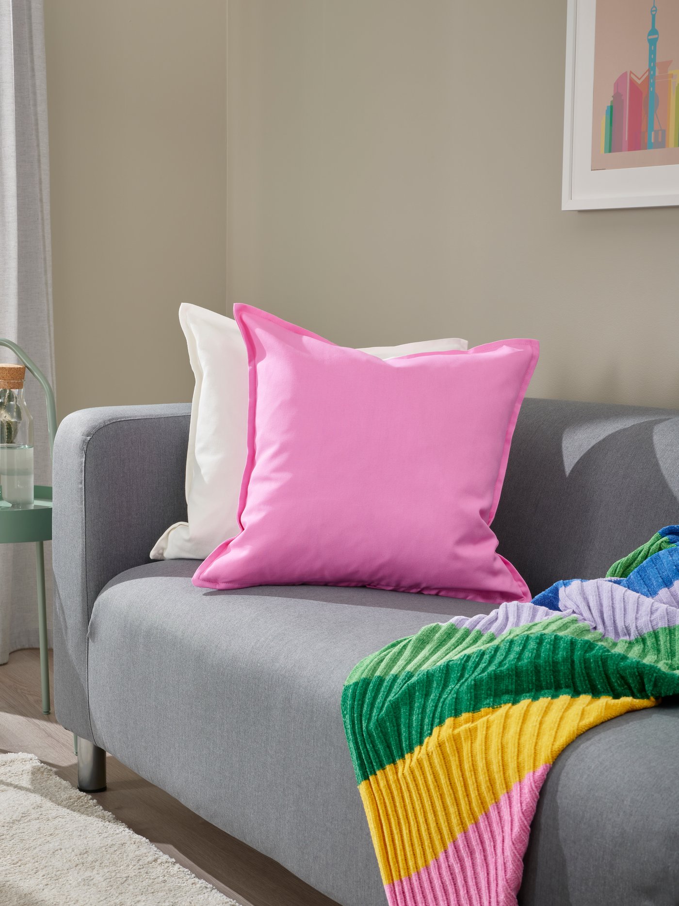 A pink GURLI cushion cover