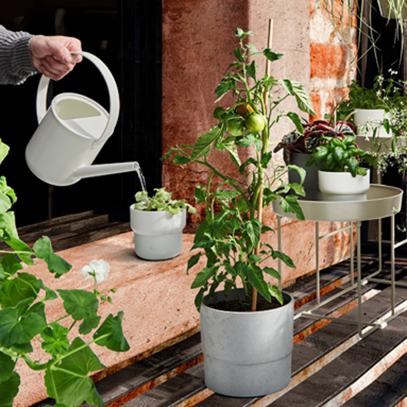 An in/outdoor grey NYPON plant pot outside
