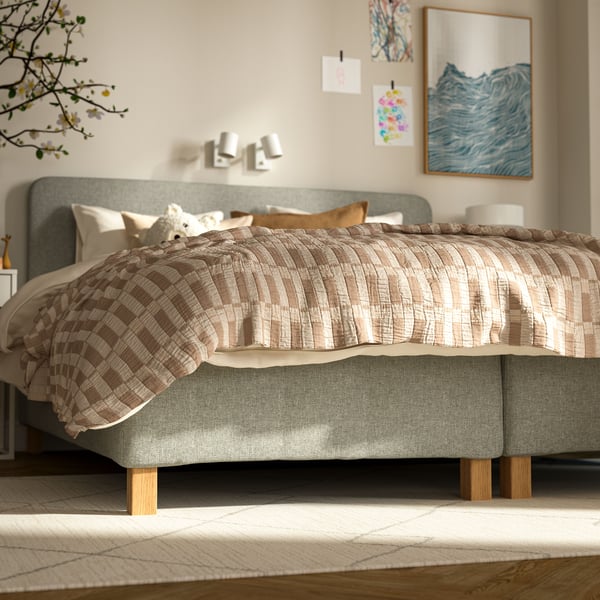 A beige TVERSTED rug, low pile in the bedroom