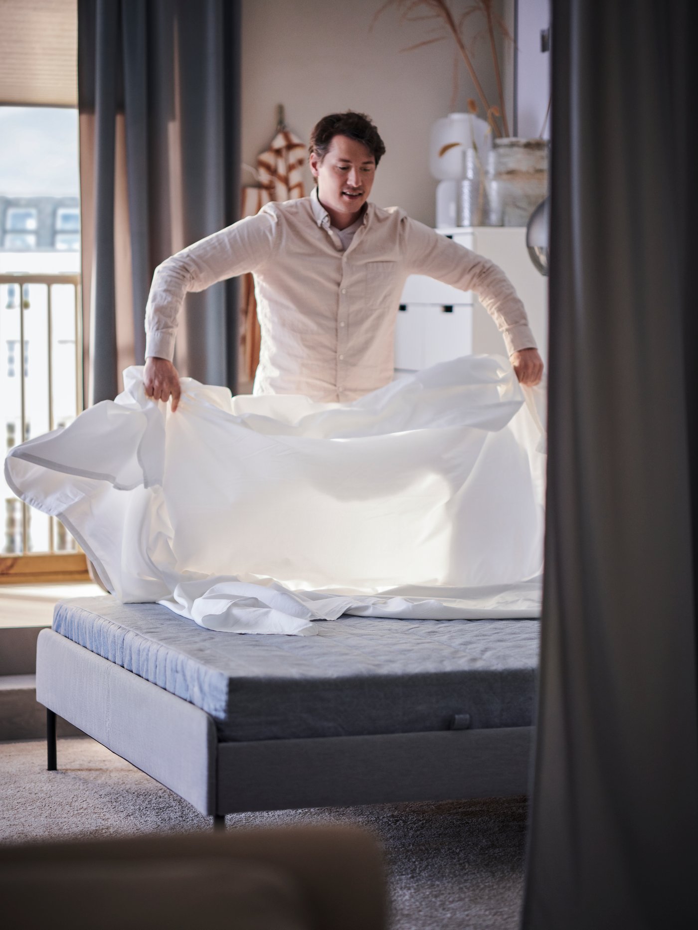 A firm/light blue VADSÖ sprung mattress in the bedroom