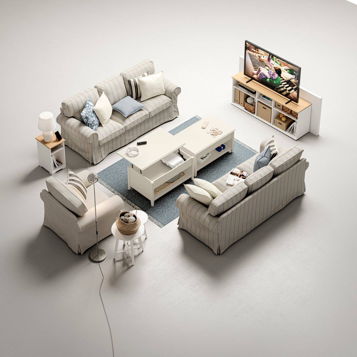 Two EKTORP 3-seat sofas and an EKTORP armchair stand around two white VITTERYD adjustable coffee tables.