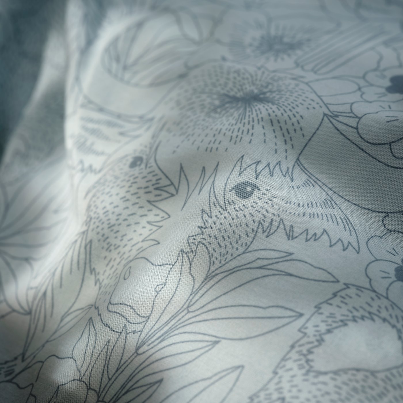 A blue/Himalayan animals and plants ALPTALL duvet cover and pillowcase in the bedroom