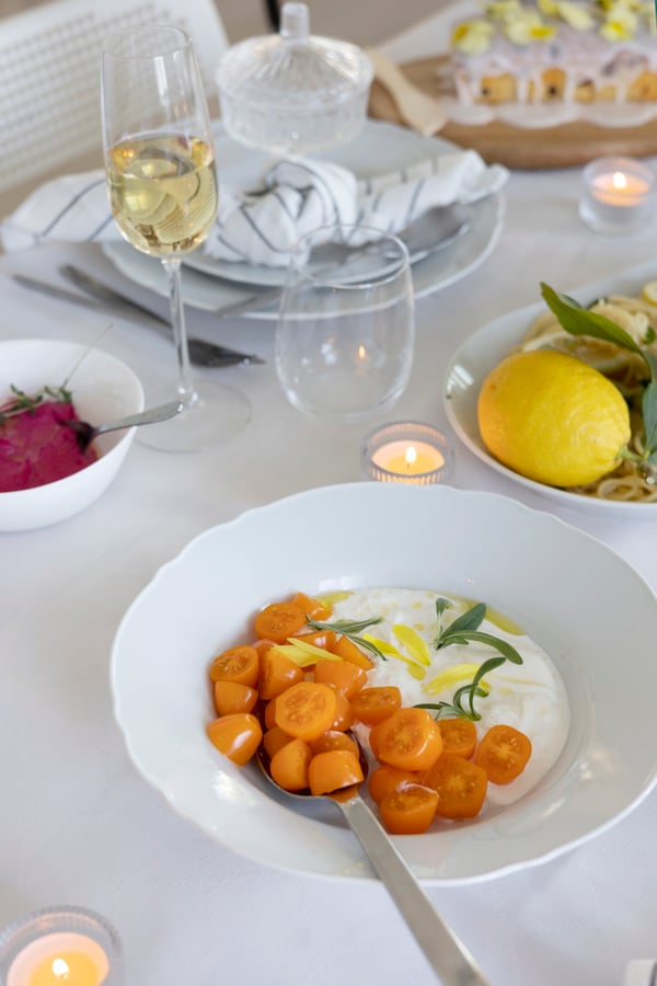 Burrata with tomatoes arranged on a plate