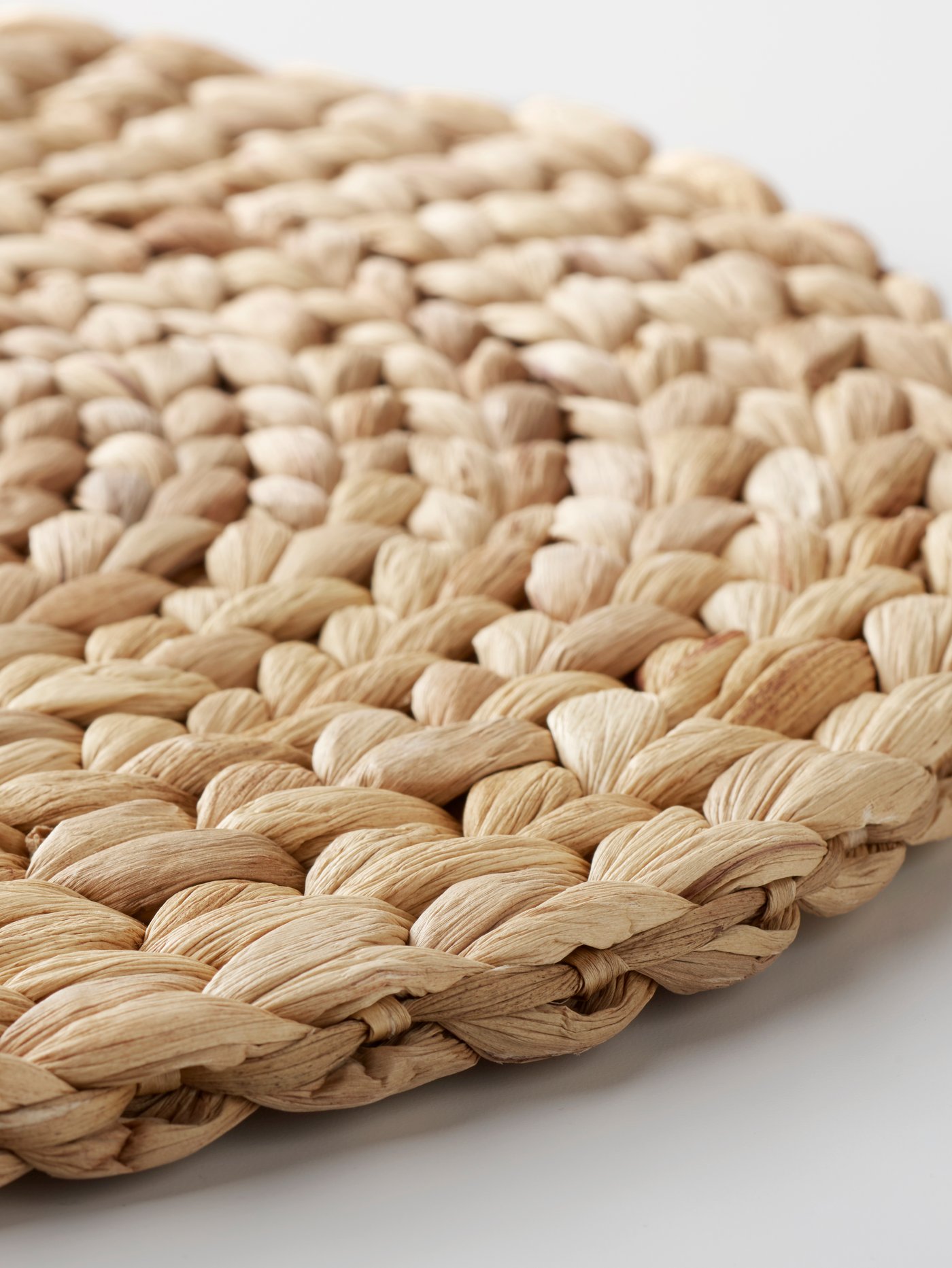 A single SOARÉ place mat laying on a white surface.