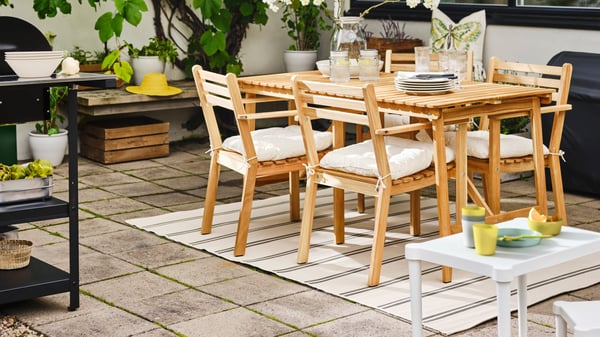 Outdoor dining set on a rug in a patio space