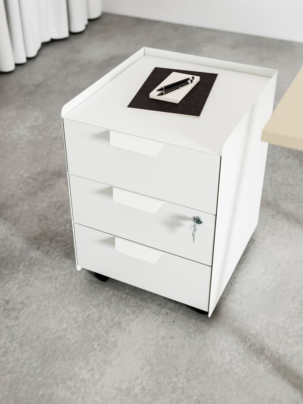A white TROTTEN drawer unit w 3 drawers on castors in the home office
