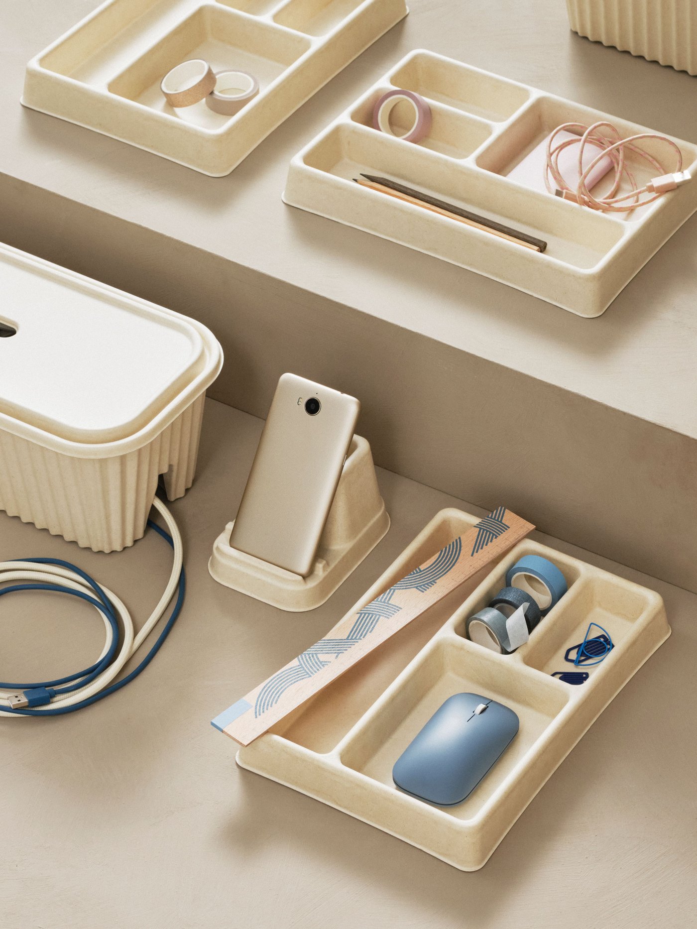 A natural HÖNSNÄT cable organizer for drawer.