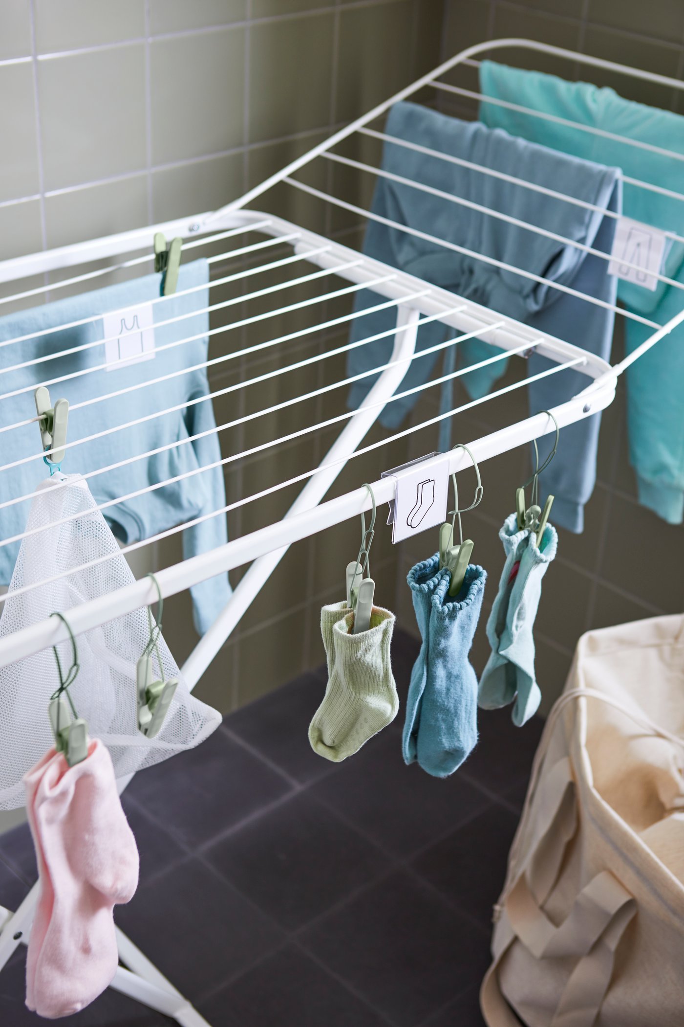 A green SLIBB hanging clothes peg