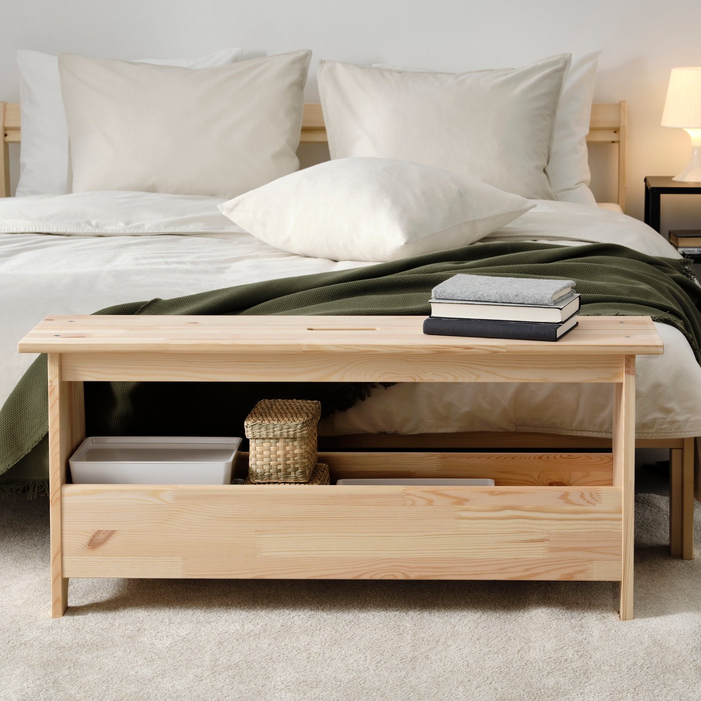 A pine PERJOHAN bench with storage in the bedroom