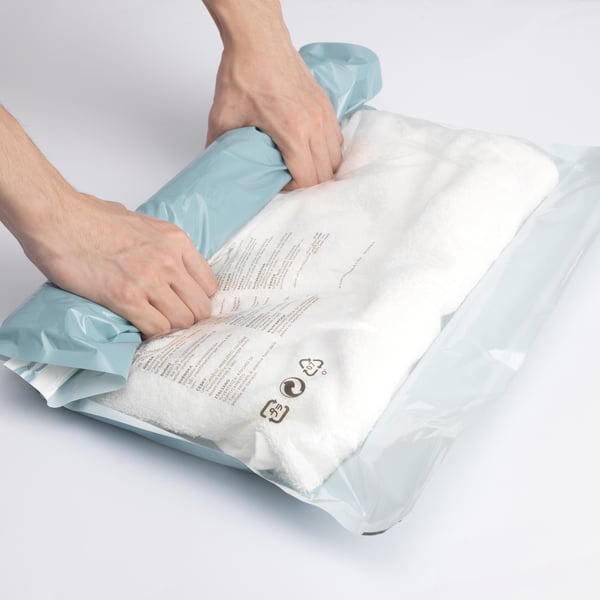 A light blue SPANTAD vacuum-sealed bag roll-up