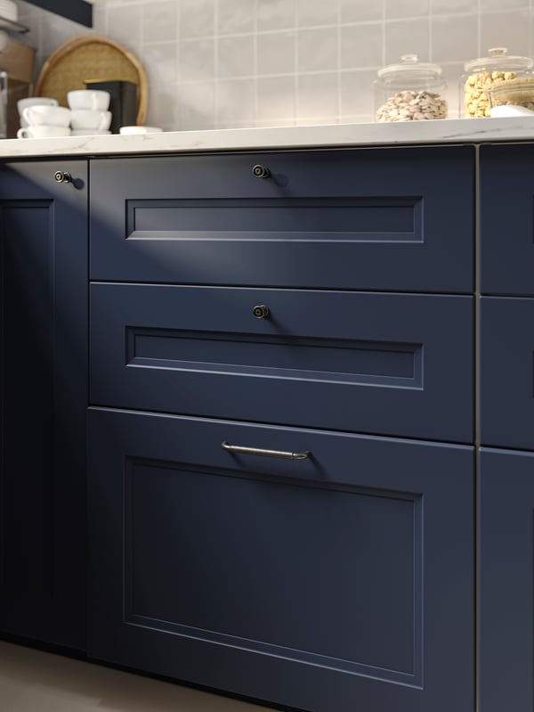 AXSTAD blue shaker drawers cabinets with silver knobs.