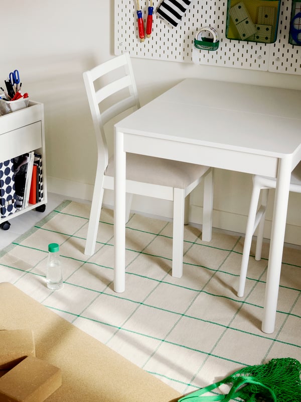 A TONSTAD extendable table in white in a room with TONSTAD chairs in white and a TONSTAD drawer unit on castors in white.