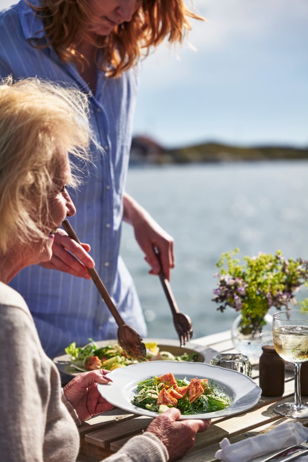 Woman serves food to other woman