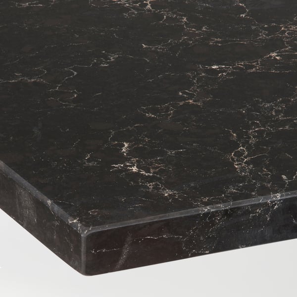 Close-up of a black marble-look countertop with white and light brown veining and a glossy finish.