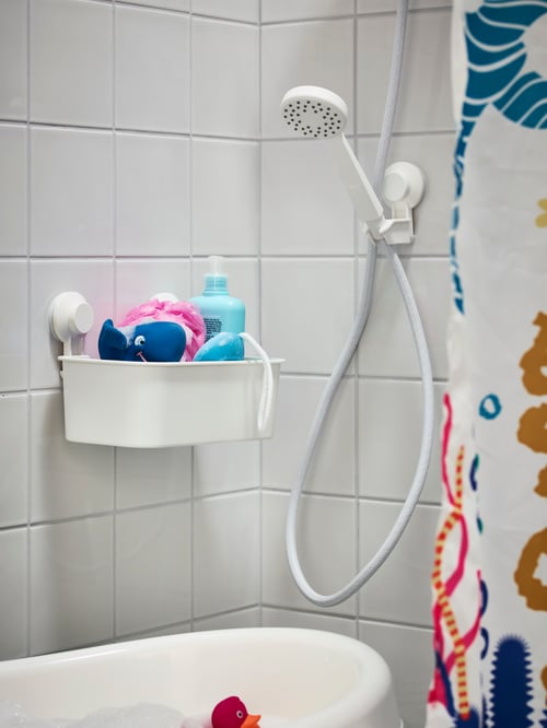 Bathroom with baby bath, basket with suction cup, single-spray hand shower, hand shower park bracket, shower curtain, toys.