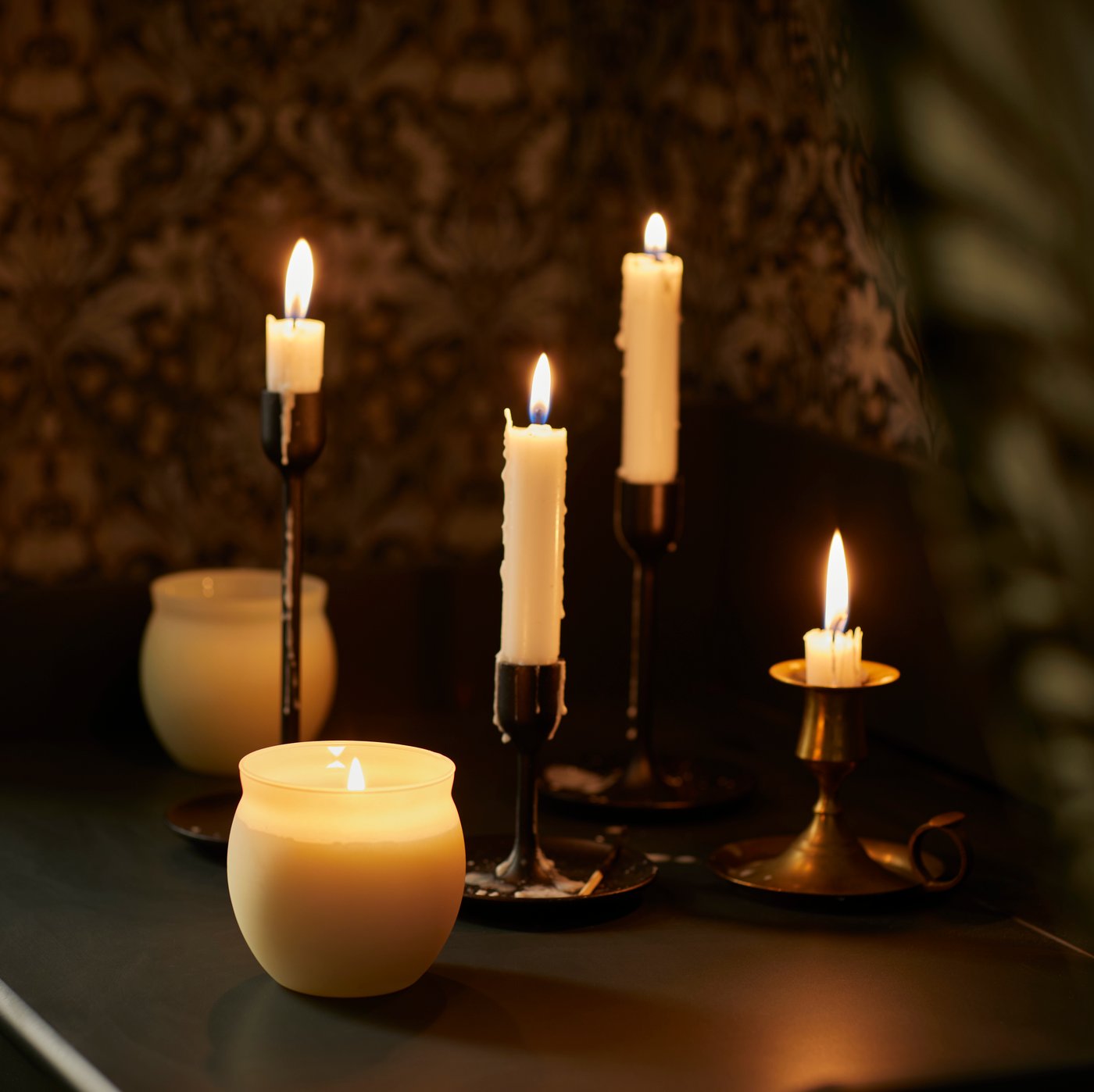 Warm candle arrangement with elegant holders creating cozy festive ambiance from IKEA Qatar