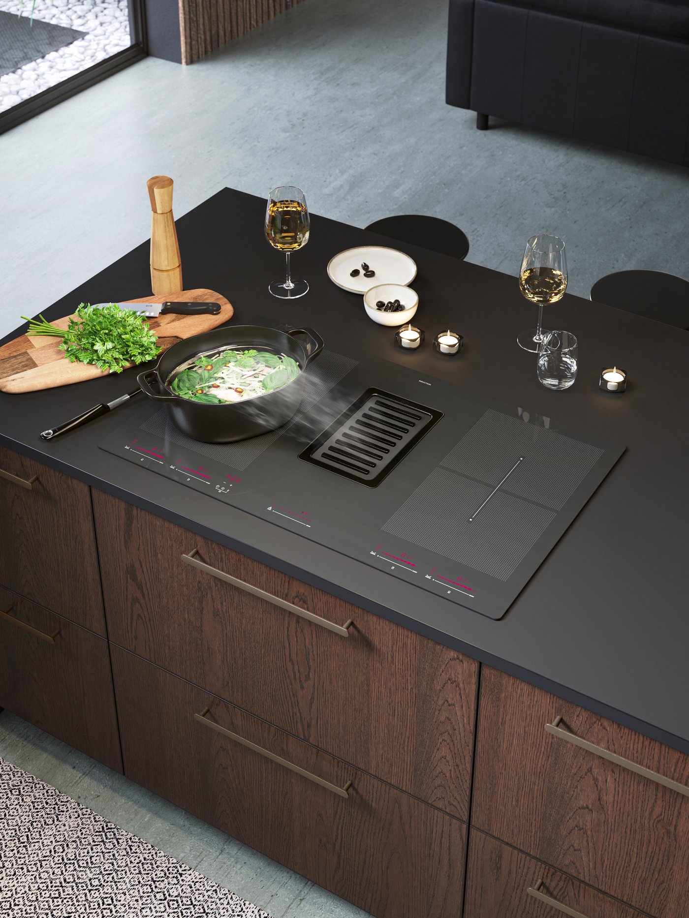 A cast iron VARDAGEN casserole on an induction hob with integrated extraction in the kitchen