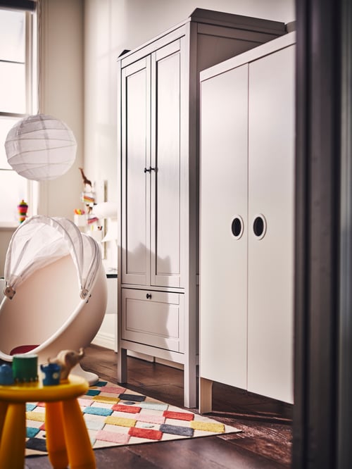 Kinderzimmer mit einem SUNDVIK und einem BUSUNGE Kleiderschrank, u. a. mit einem IKEA PS LÖMSK Drehsessel.