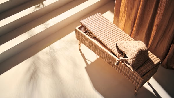 A handmade rattan TOLKNING bench with storage