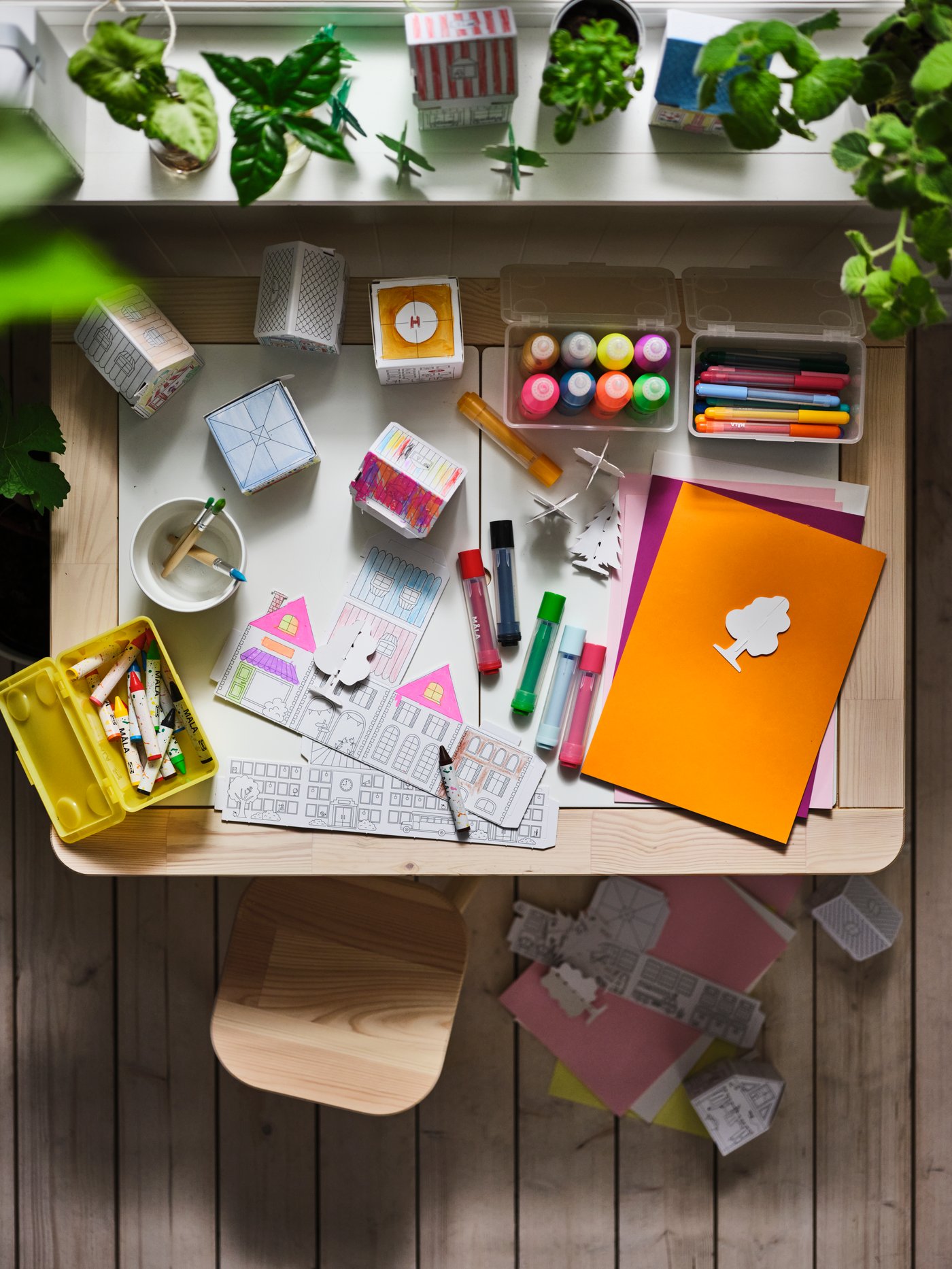MALA colouring pencils and paper on children's desk.