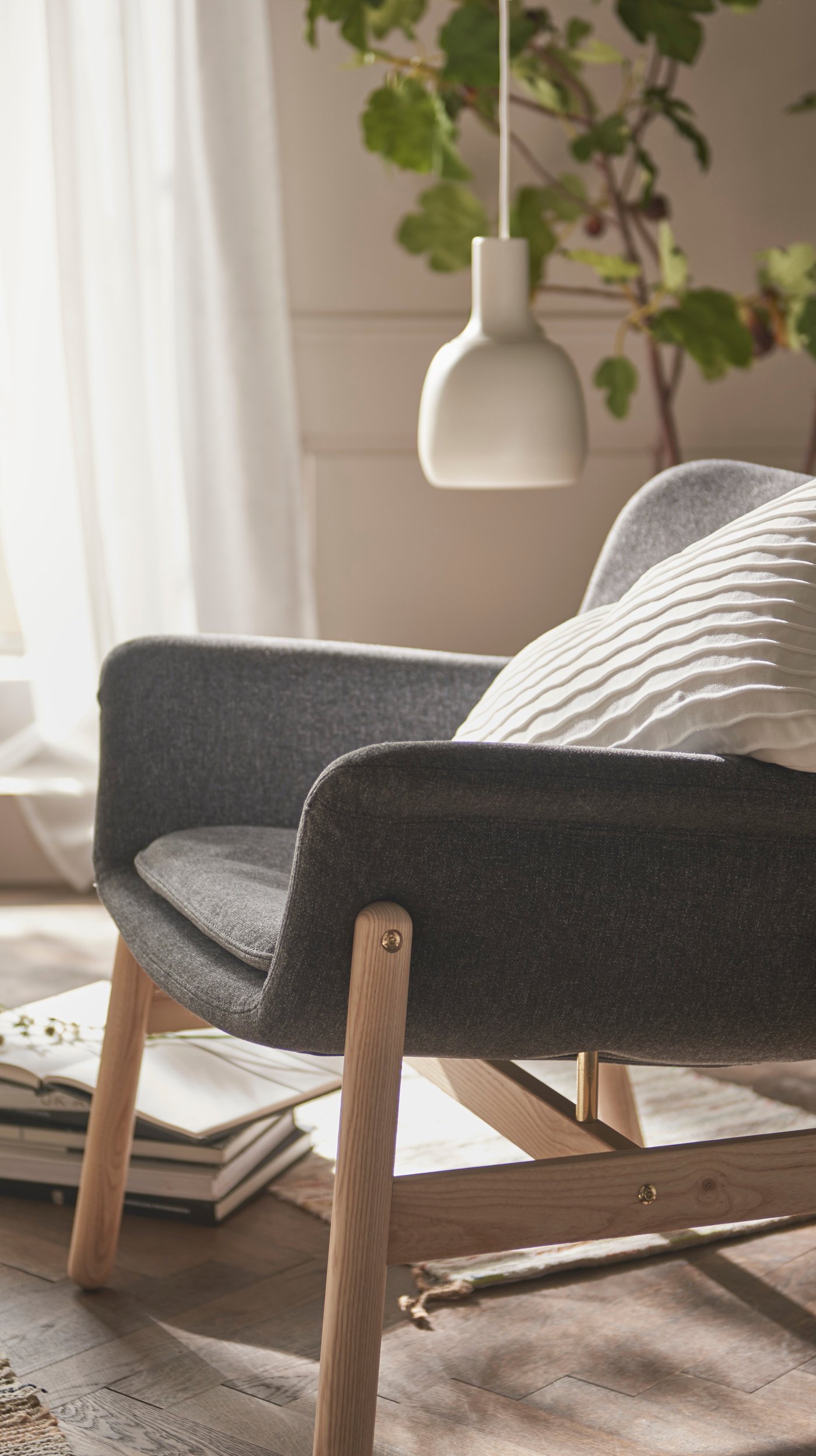 A Gunnared dark grey VEDBO armchair in the bedroom