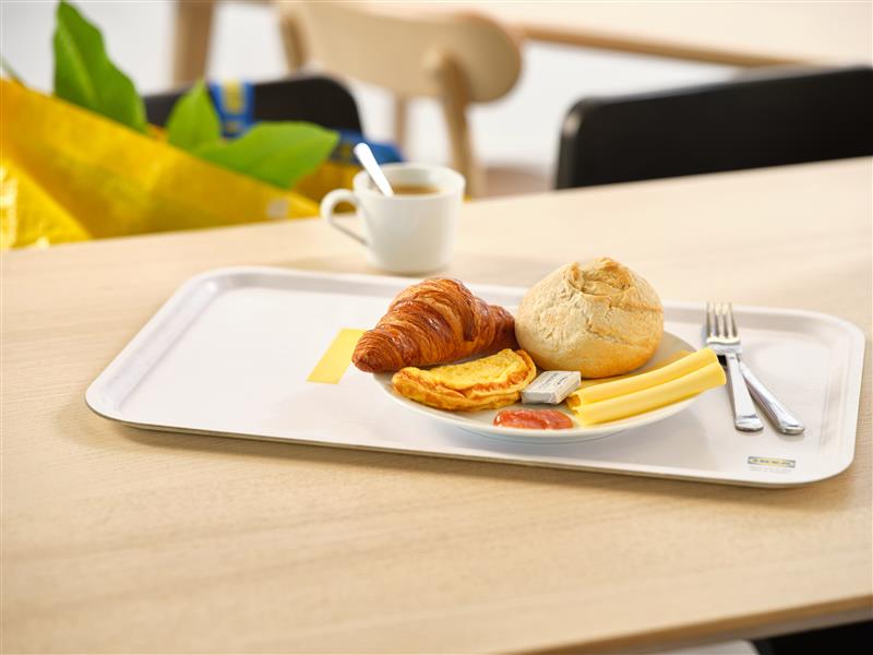 IKEA breakfast consisting of an artisan roll, a butter croissant, 2 slices of cheese, an omelette, jam and butter.