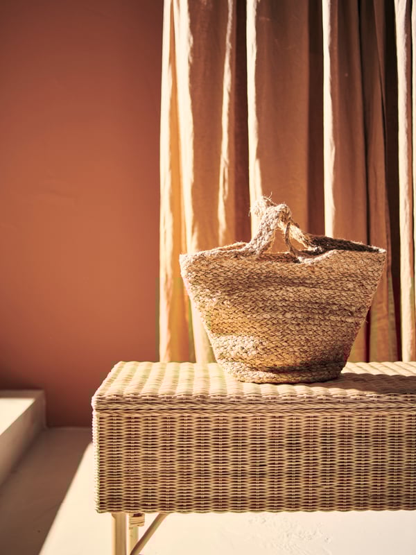 TOLKNING storage bench and TOLKNING shopping cart in front of red walls and curtains.