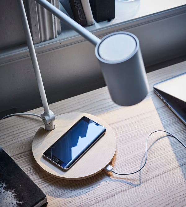Want a work lamp that blends in with your living room and also fits your home office? Try IKEA RIGGAD; a work lamp and wireless charger in one. The wood and soft design give it a look that’s different to most technical products.