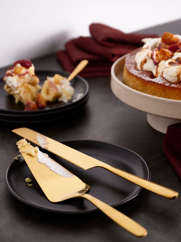 A brass-colour TILLAGD 2-piece serving set