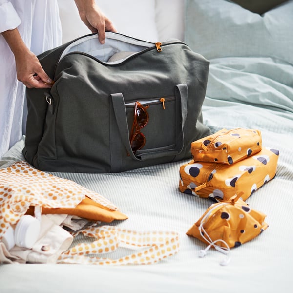An yellow/white SKYNKE carrier bag in the bedroom