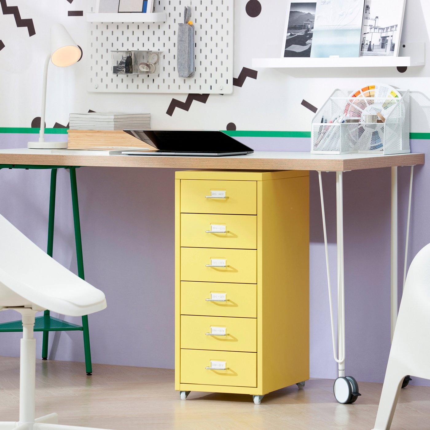 A desk with a yellow drawer unit underneath