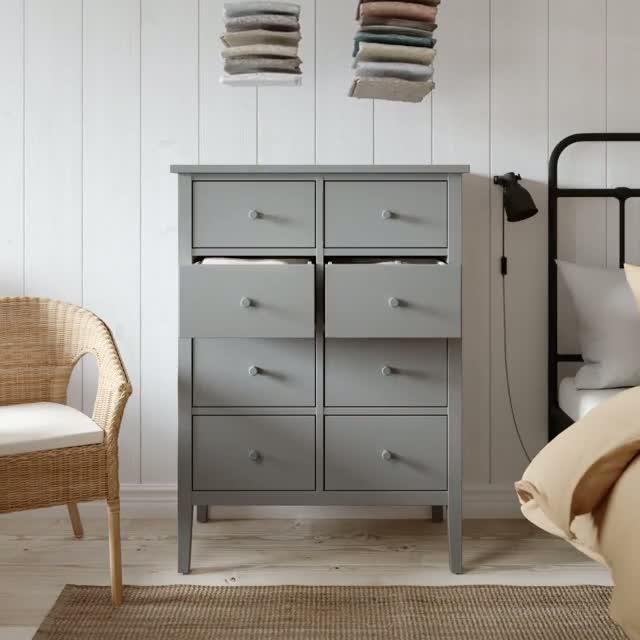 Video of folded clothes being organized into gray GULLABERG 8 drawer dresser