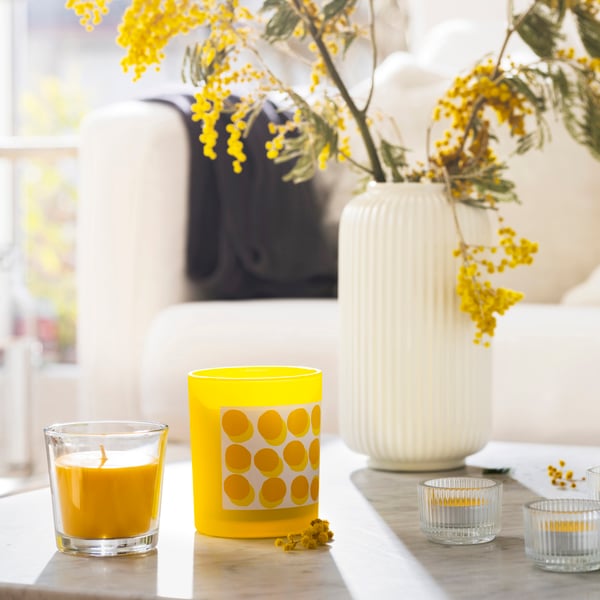 A clear glass FINSMAK tealight holder