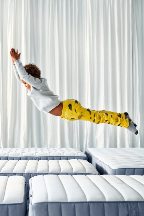 A firm/light blue VESTERÖY pocket sprung mattress