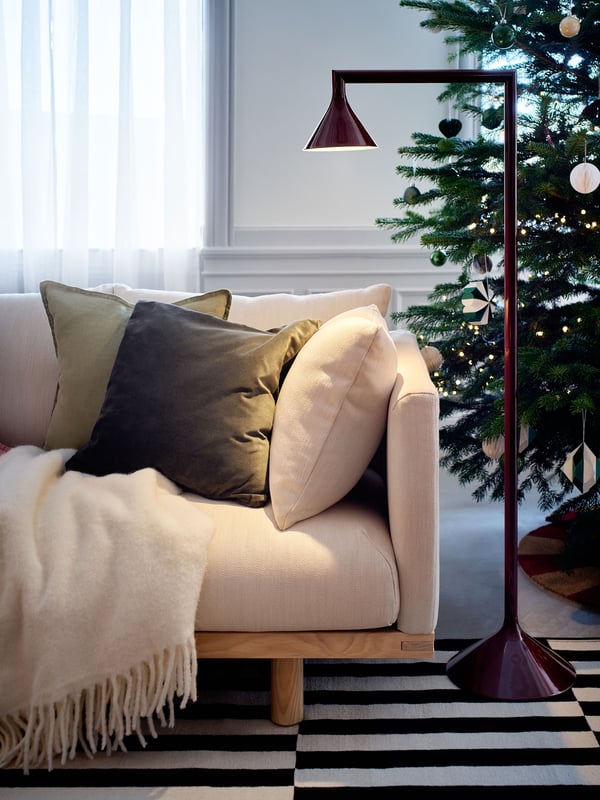 A dark green SANELA cushion cover