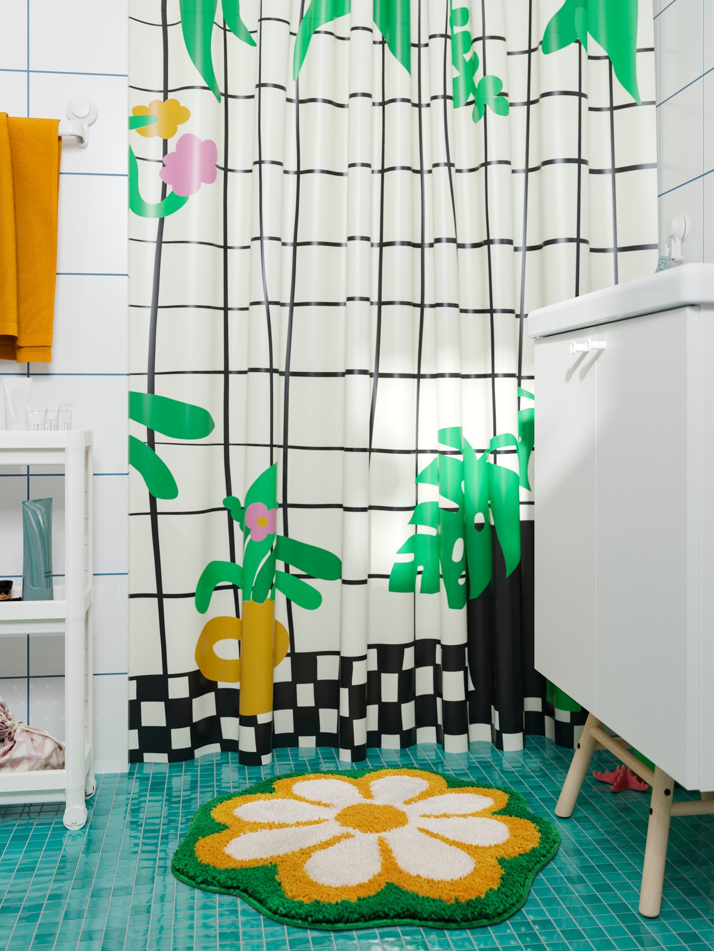 Una alfombra de baño floral en amarillo y verde, y una cortina de regadera con exuberantes hojas verdes y toques de amarillo y negro detrás.