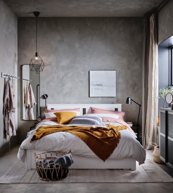 A black SKURUP wall lamp in the bedroom