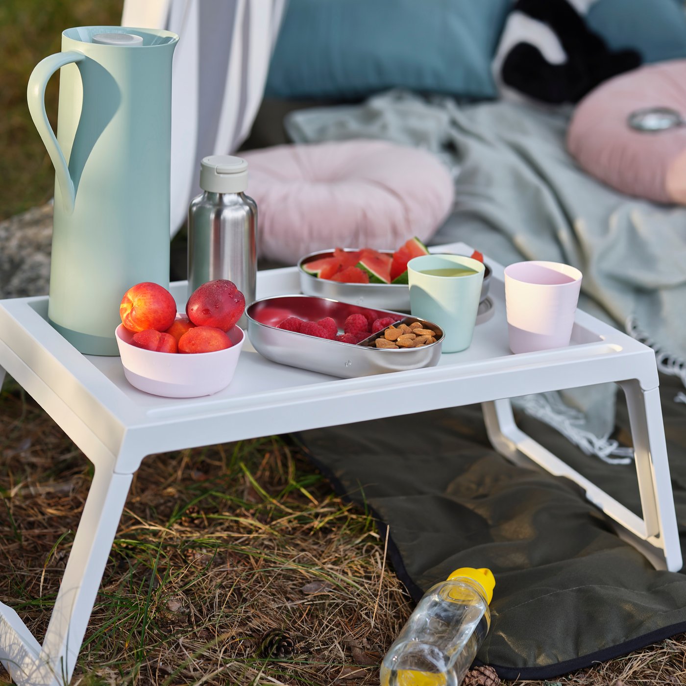 A white KLIPSK bed tray outside