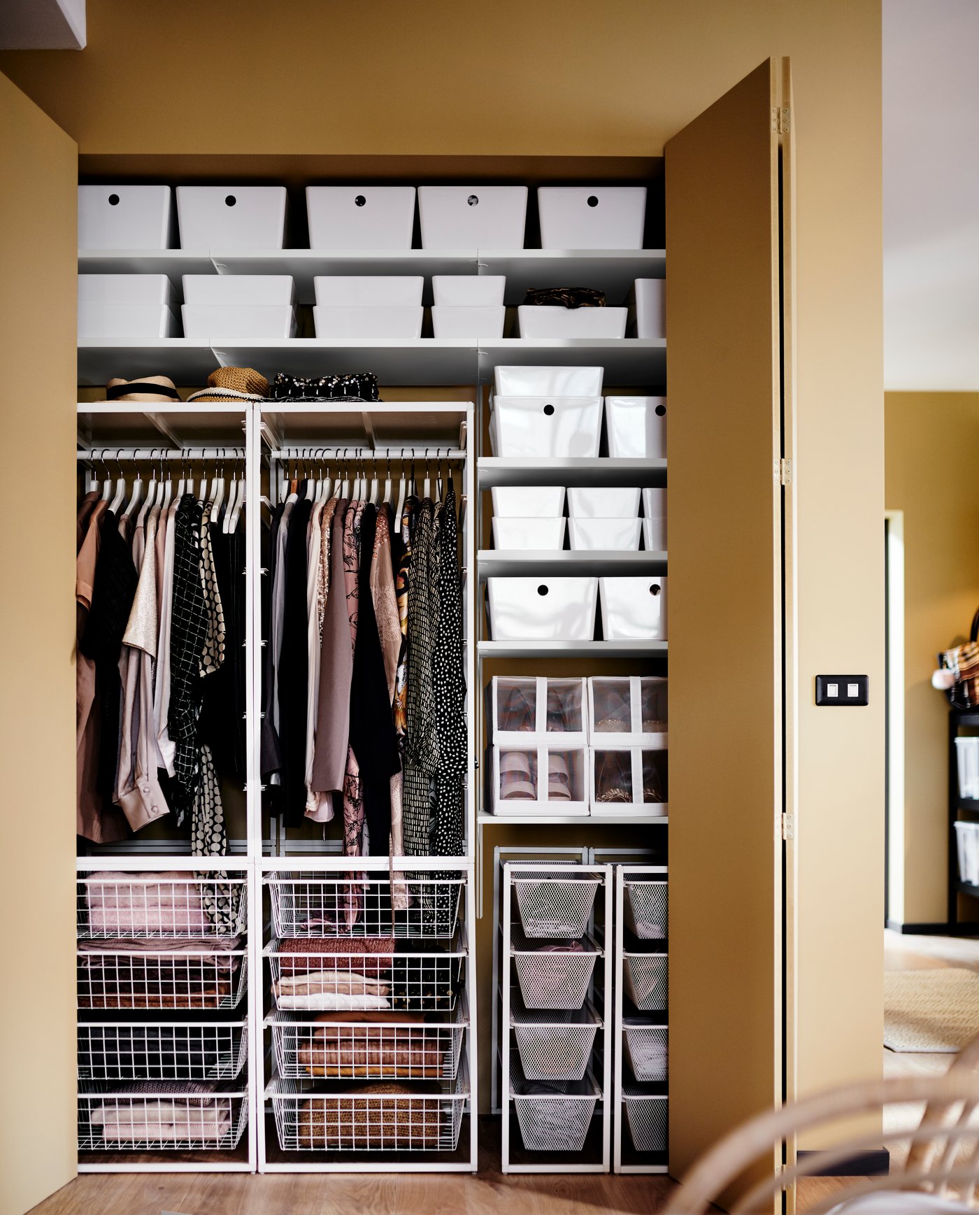 A white JONAXEL wardrobe combination in the bedroom