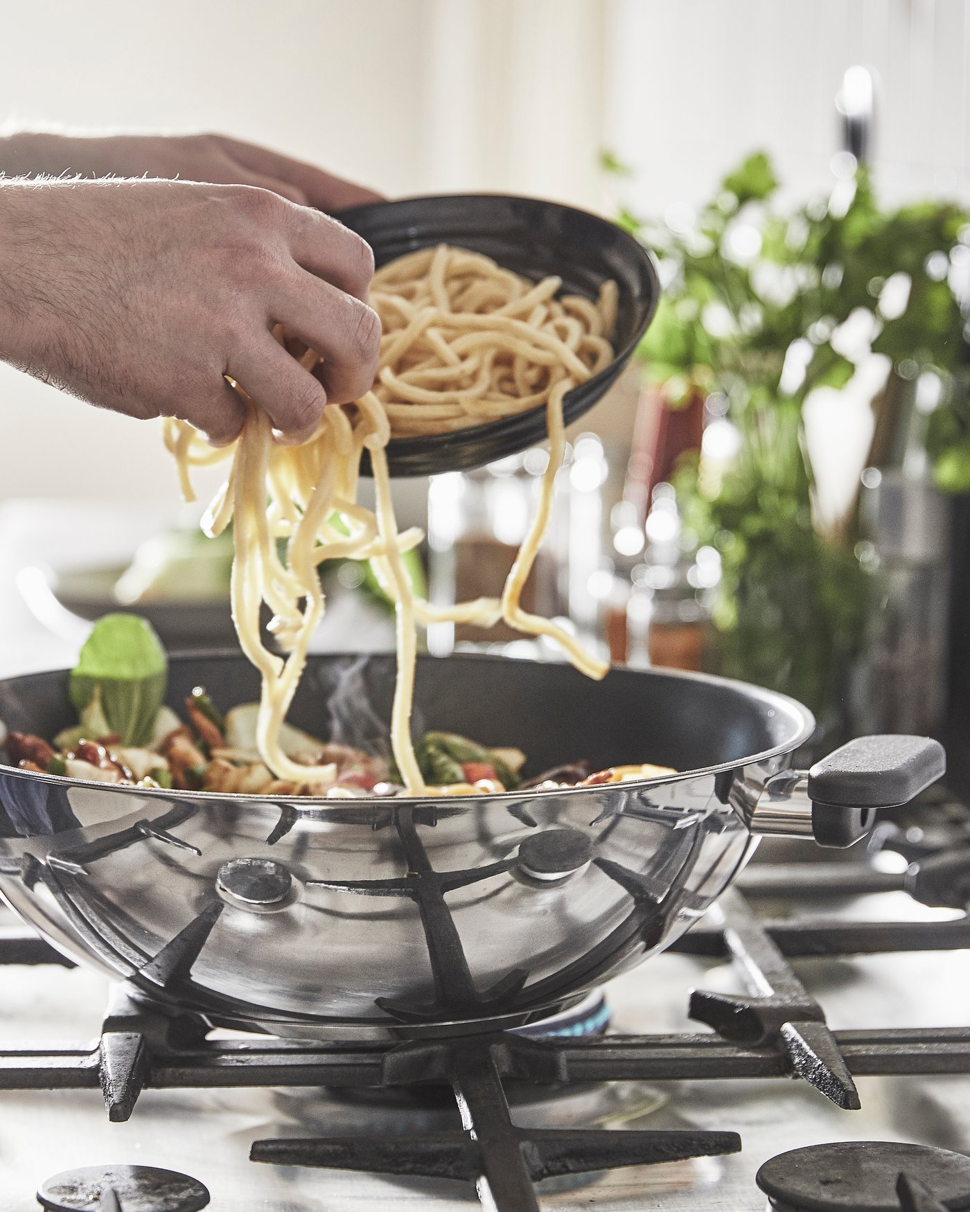 A non-stick coating/stainless steel MIDDAGSMAT wok in the kitchen