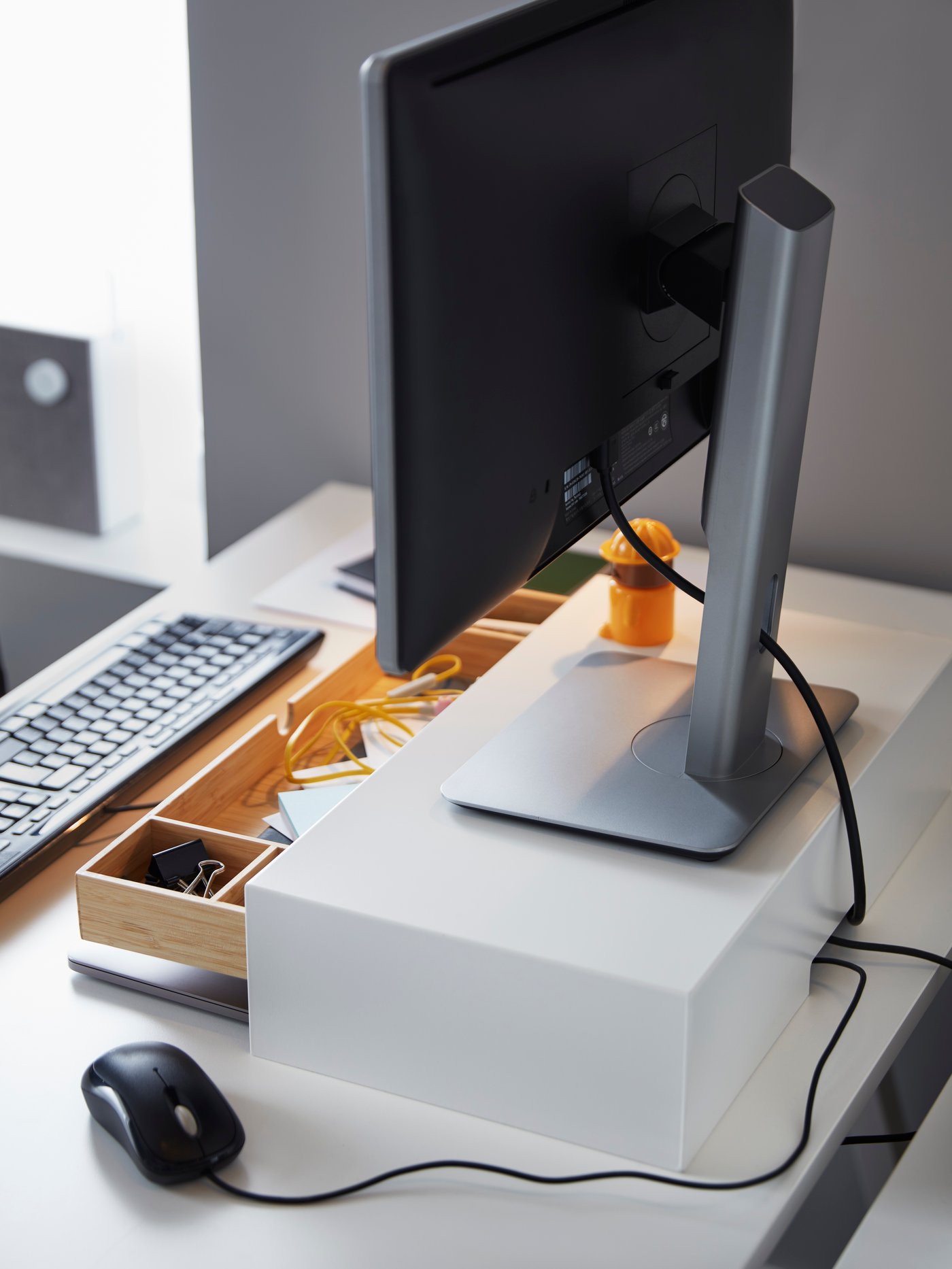 A white ELLOVEN monitor stand with drawer
