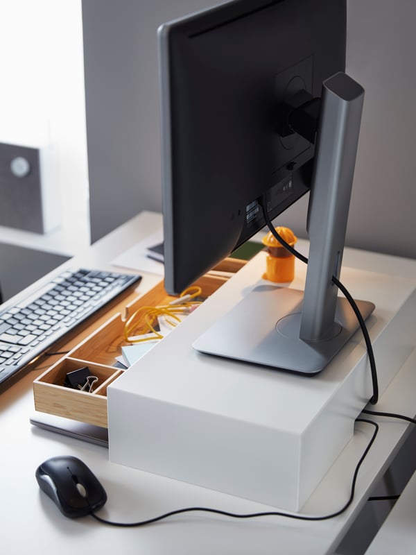 A white ELLOVEN monitor stand with drawer.