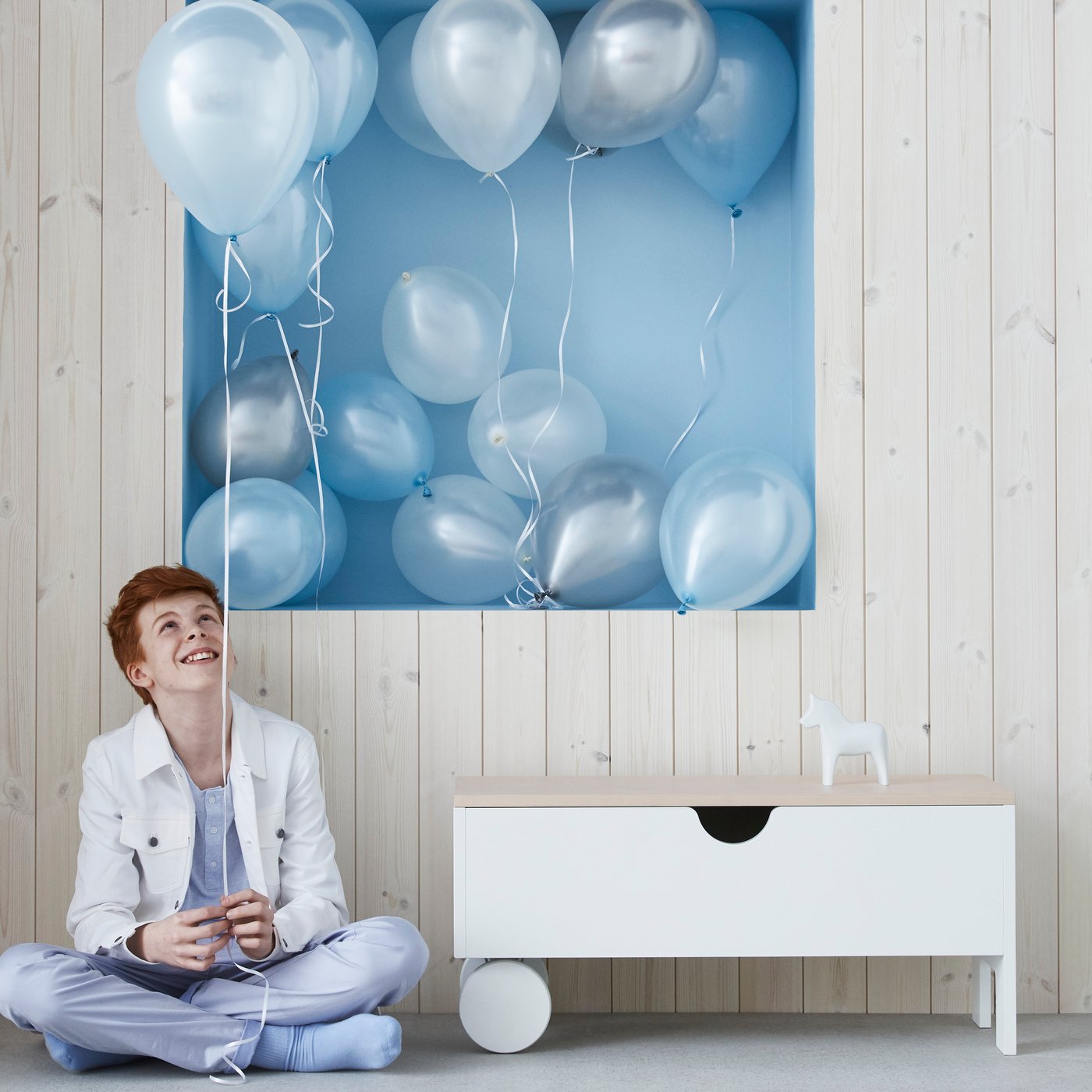 A white IKEA PS 1995 storage bench