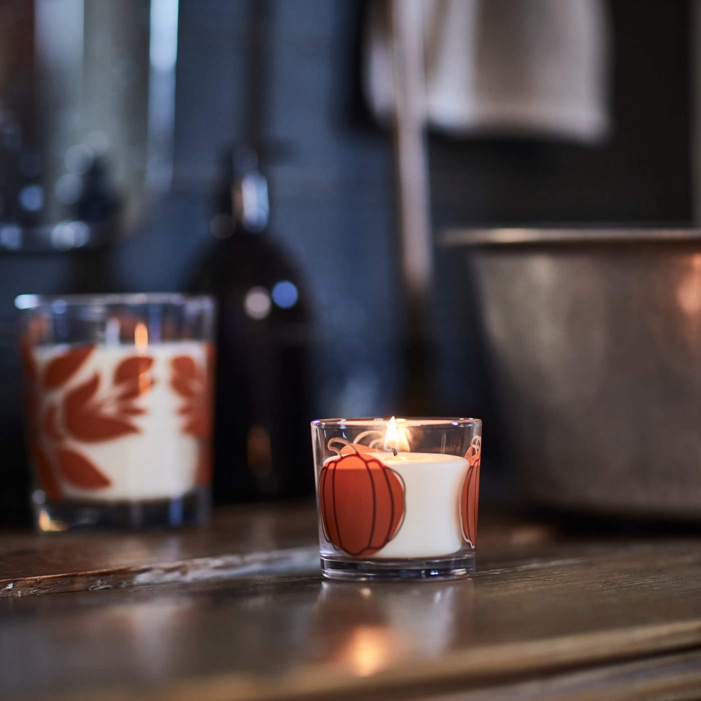 A Vanilla & apple clear glass/orange HÖSTAGILLE scented candle in glass